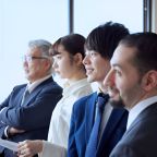 Photo of four Westerners and a Japanese businessman side by side.